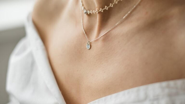 woman in white off shoulder shirt wearing silver necklace